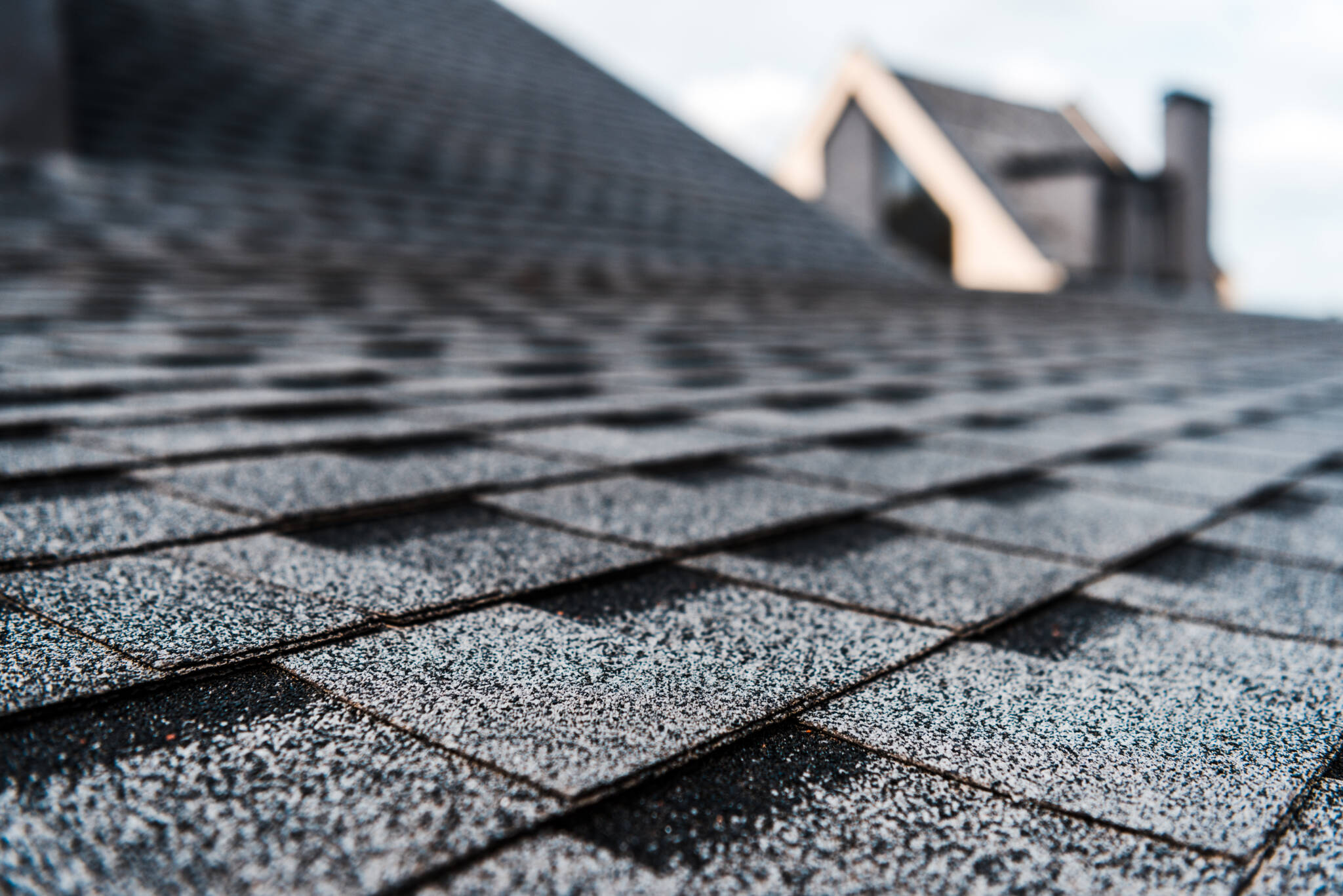 Selective Focus Of Grey Shingles On Rooftop Of Building