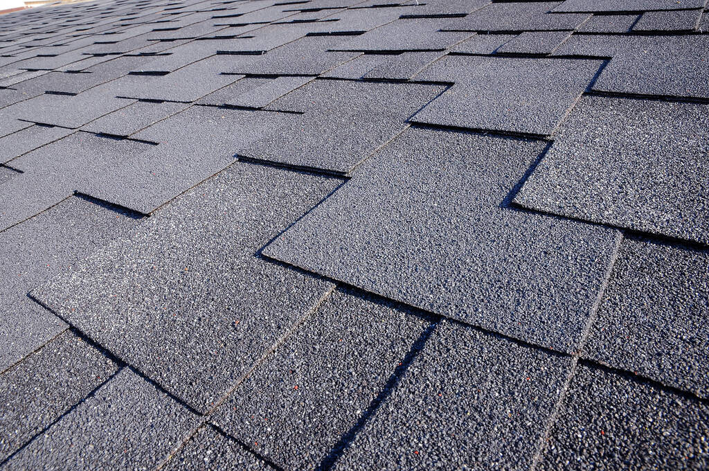 A closeup of asphalt roofing shingles on a residential roof