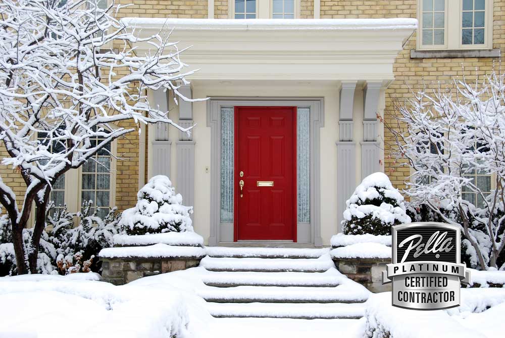 Red front door on home in winter