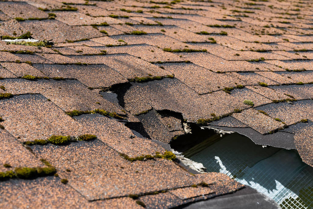 damaged-roof-with-cracked-shingles