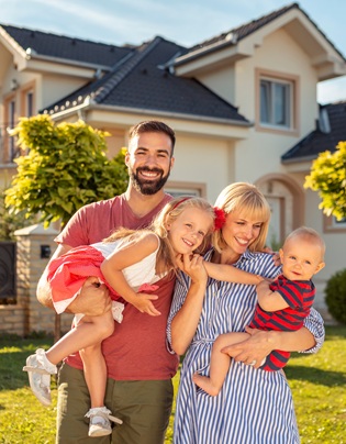 Family Standing In Front Of Their New House