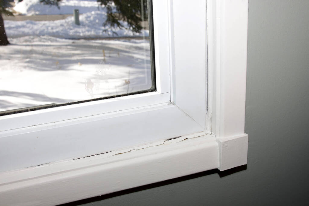window with deteriorating and broken caulk seal