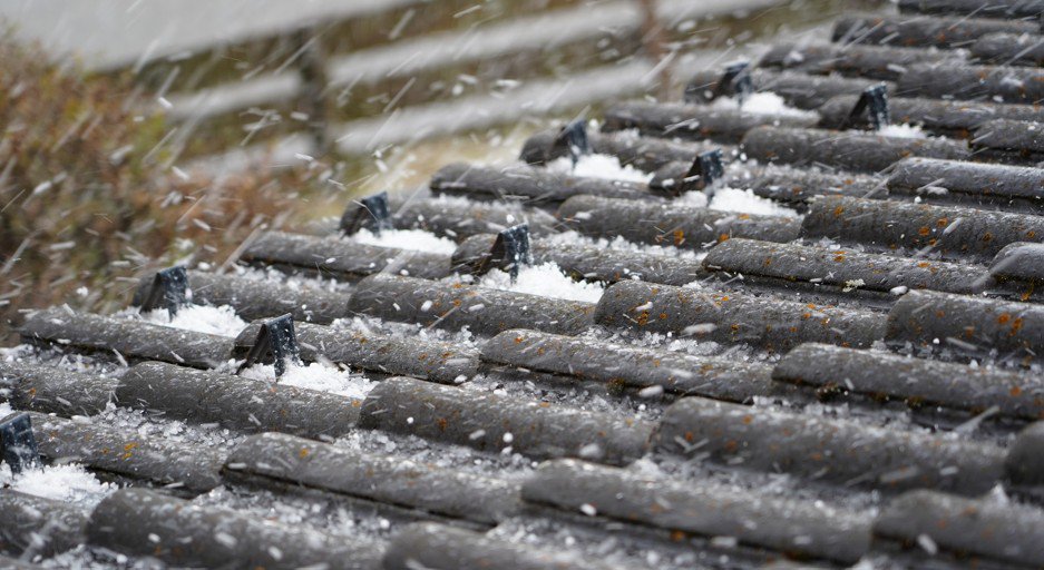Hail falling on tile roof before hail damage roof repair is needed