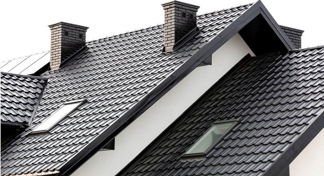 Completed metal roofing installation with chimneys and skylights