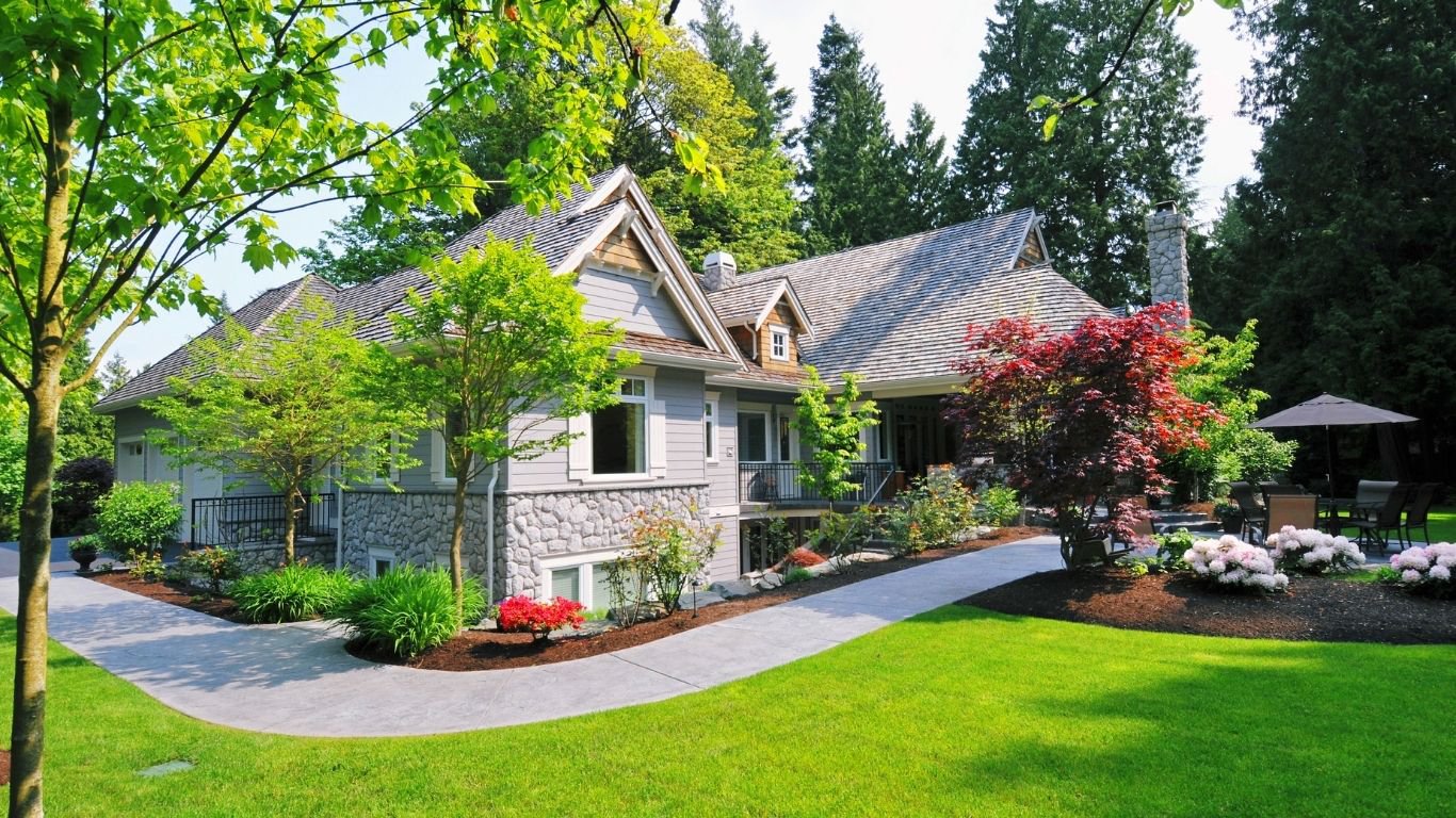An updated home with matching siding, roof, and entry details showcasing Curb Appeal Ideas.
